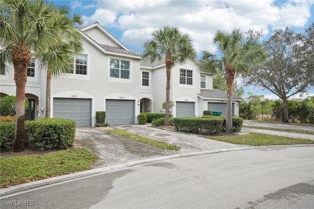 16118 Ravina Way, Naples, FL 34110 - view of property with stucco siding, an attached garage, and driveway