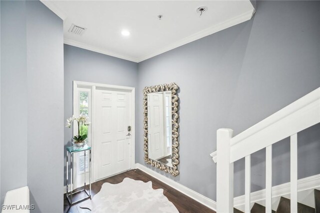 entrance foyer featuring dark wood-type flooring and crown molding