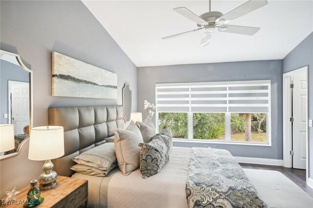 bedroom featuring ceiling fan, lofted ceiling, and hardwood / wood-style floors