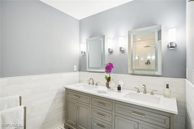 bathroom with vanity, a shower, and tile walls