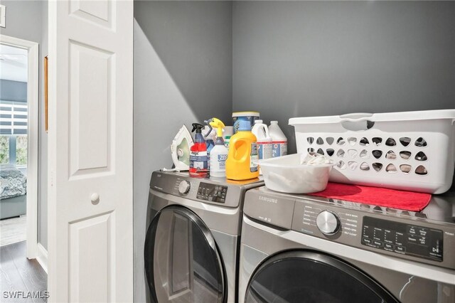 laundry room with wood-type flooring and independent washer and dryer