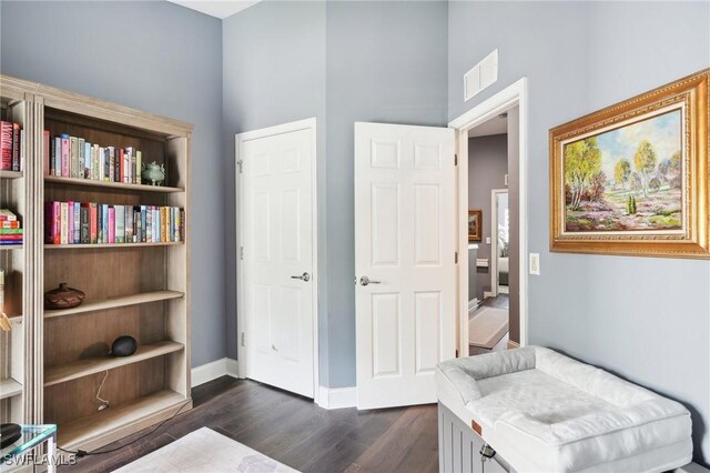 sitting room with dark wood-type flooring