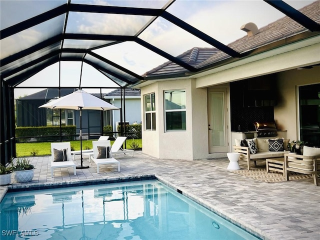 view of pool featuring a lanai, a patio area, a grill, and an outdoor hangout area