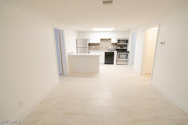 kitchen with white cabinets, crown molding, decorative backsplash, a textured ceiling, and appliances with stainless steel finishes