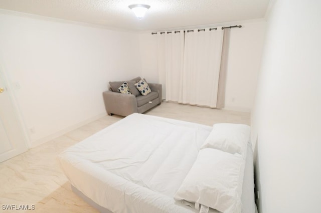 bedroom with a textured ceiling and ornamental molding