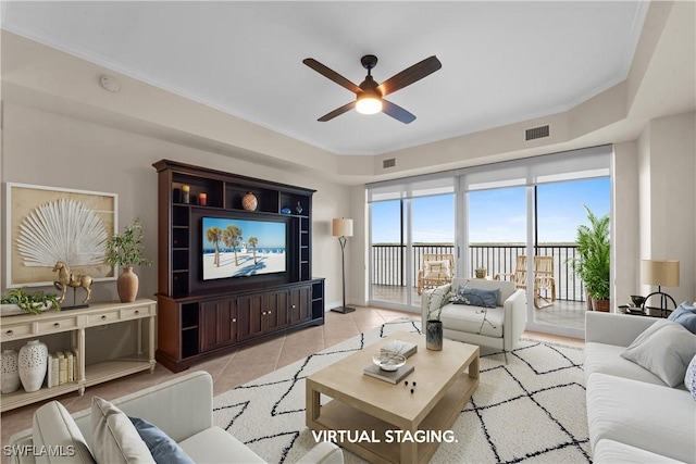 living room featuring light tile patterned floors, ceiling fan, and ornamental molding