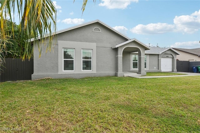 ranch-style house featuring a garage and a front lawn