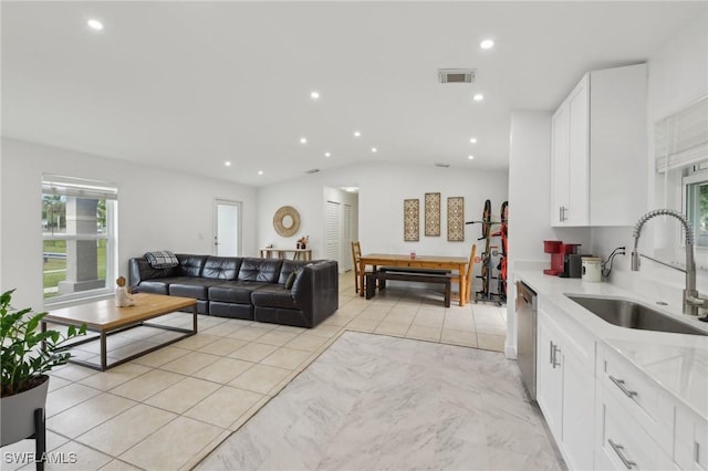 living room with light tile patterned floors and sink