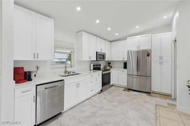 kitchen with white cabinets, sink, and appliances with stainless steel finishes