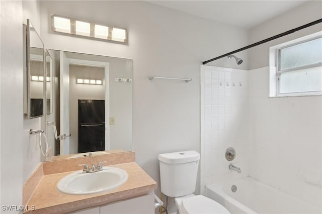 full bathroom with vanity, tiled shower / bath, and toilet