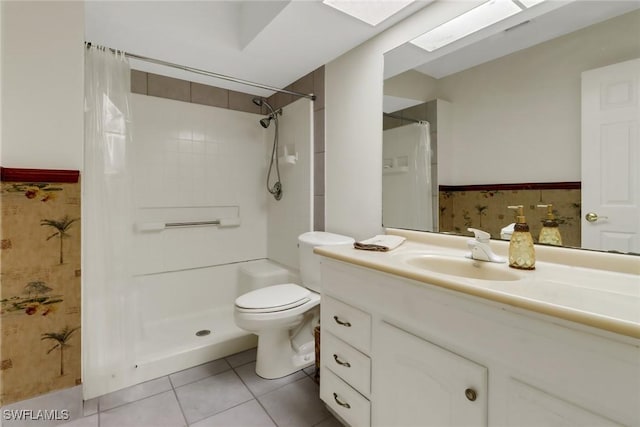 bathroom with a shower with curtain, vanity, a skylight, and toilet