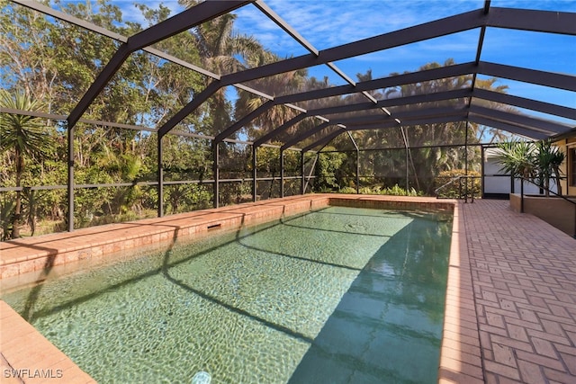 view of swimming pool with a patio and a lanai