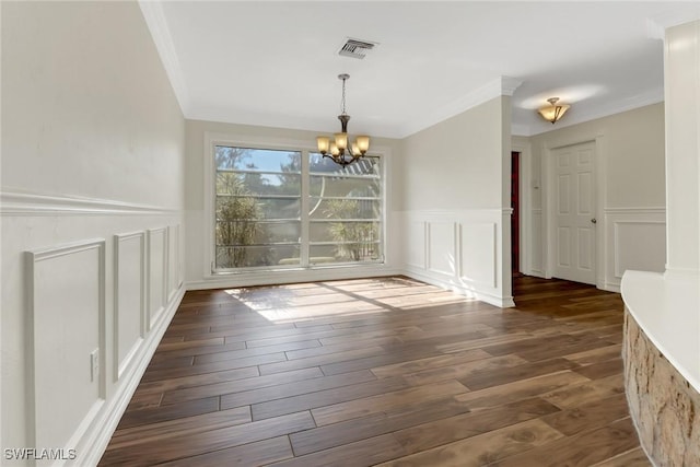 unfurnished dining area with a chandelier, dark hardwood / wood-style floors, and crown molding