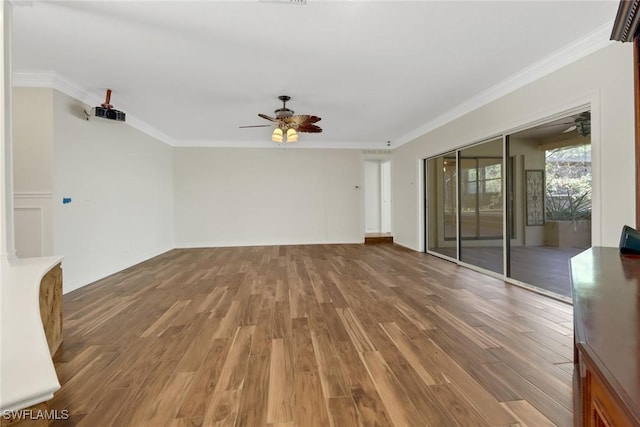 spare room featuring ceiling fan, wood-type flooring, and ornamental molding