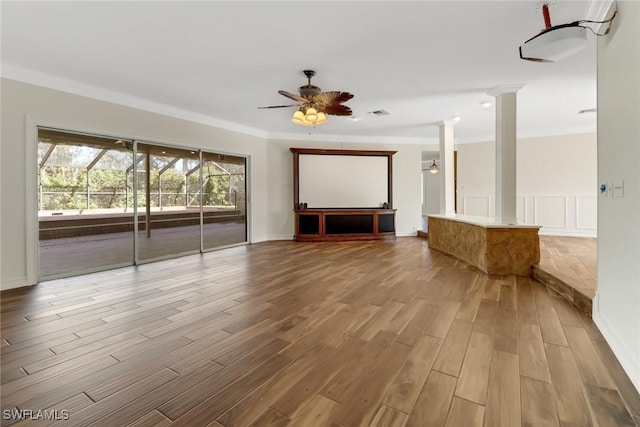 unfurnished living room with ceiling fan, light wood-type flooring, and crown molding