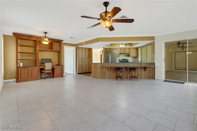 unfurnished living room with crown molding and light tile patterned floors