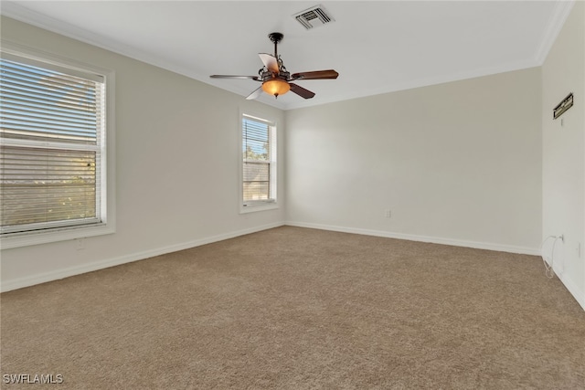 empty room with carpet floors, ceiling fan, and crown molding