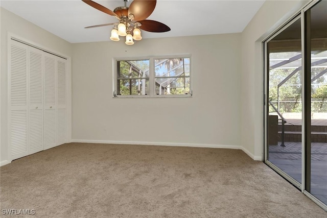 unfurnished bedroom featuring ceiling fan, multiple windows, access to outside, and a closet