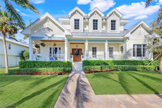 view of front of property featuring covered porch and a front lawn