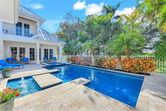 view of swimming pool featuring french doors, an in ground hot tub, and a patio