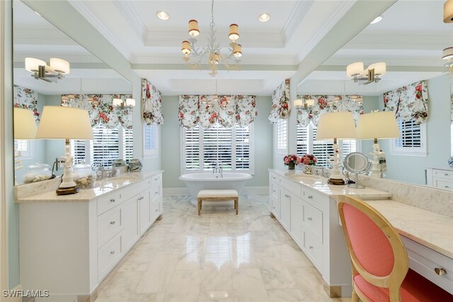 bathroom featuring vanity, a tub, plenty of natural light, and an inviting chandelier