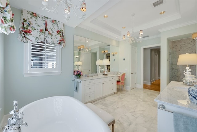 bathroom featuring a raised ceiling, vanity, a chandelier, and ornamental molding