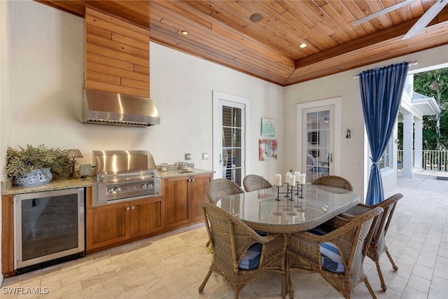 dining area with sink, beverage cooler, and wooden ceiling