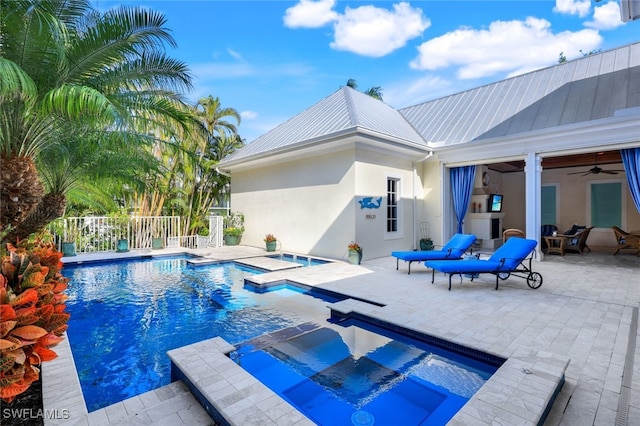 view of pool with ceiling fan, a patio area, and an in ground hot tub