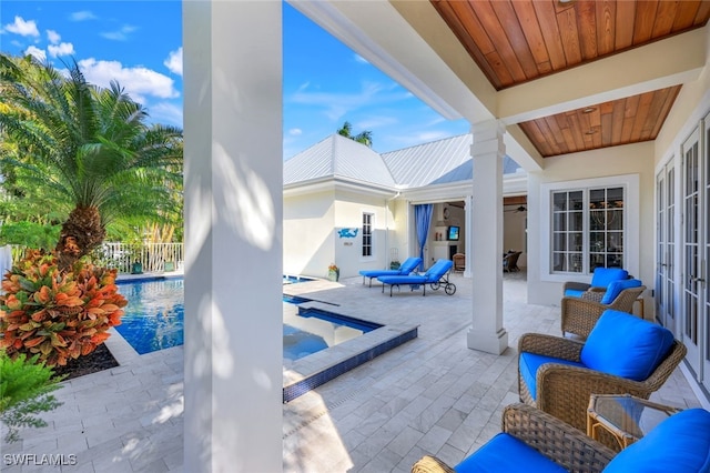 view of pool featuring a hot tub and a patio