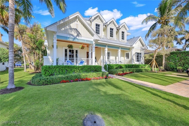 view of front of house with covered porch and a front yard