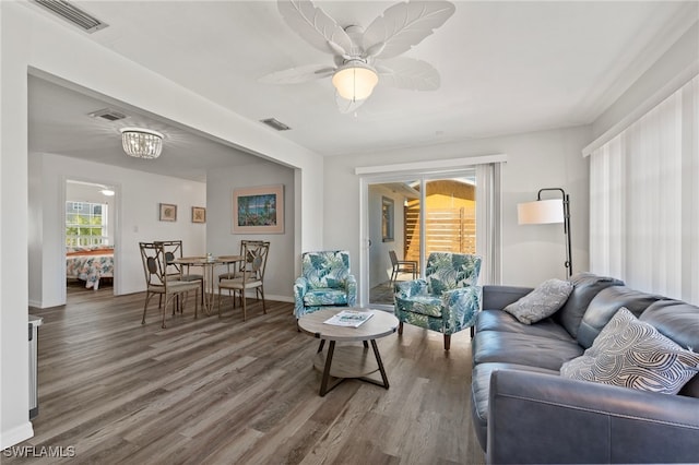 living room featuring ceiling fan and hardwood / wood-style floors