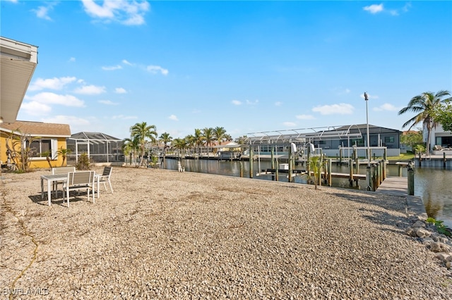 view of yard with a boat dock and a water view