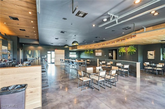 dining space featuring concrete flooring