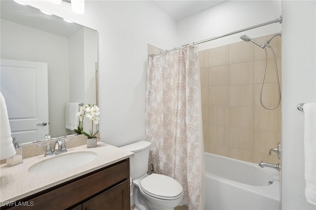 full bathroom with vanity, shower / tub combo with curtain, and toilet