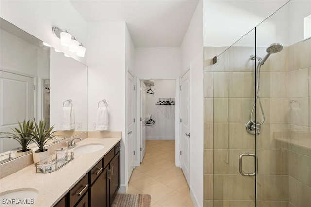 bathroom with vanity and a shower with door