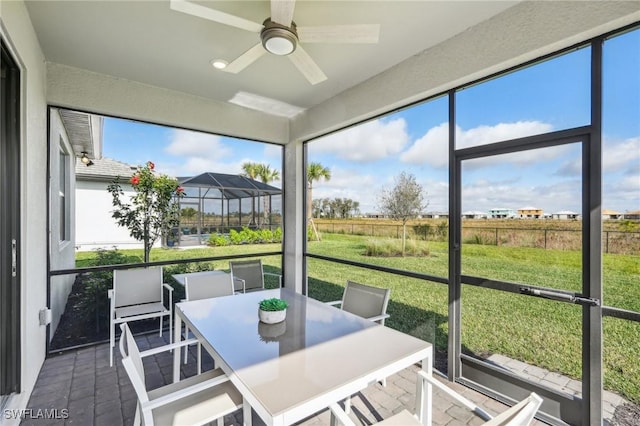 sunroom / solarium with plenty of natural light and ceiling fan