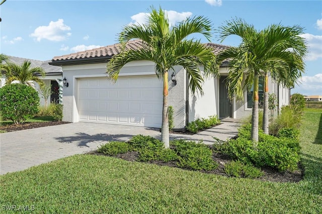 view of front of property featuring a garage and a front yard