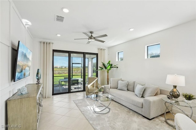 tiled living room featuring ceiling fan