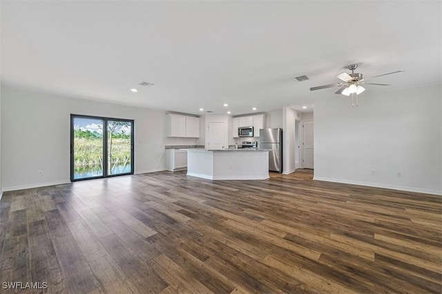 unfurnished living room with ceiling fan and dark hardwood / wood-style flooring