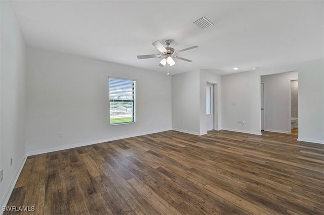 empty room featuring ceiling fan and dark hardwood / wood-style flooring