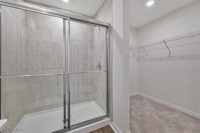 bathroom with a shower with shower door