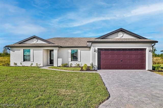 single story home featuring a garage and a front lawn