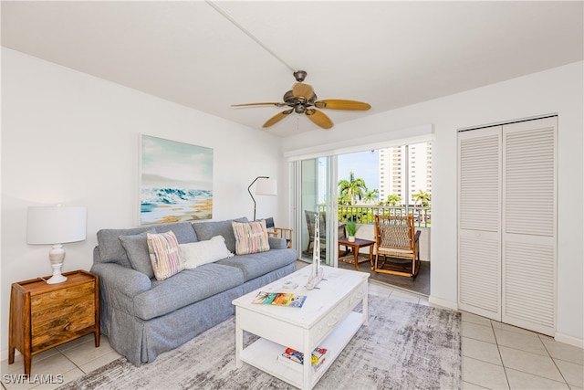 living room with ceiling fan and light tile patterned floors