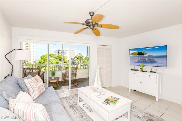 living room featuring ceiling fan and light tile patterned floors