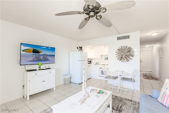 living room featuring light tile patterned floors and ceiling fan