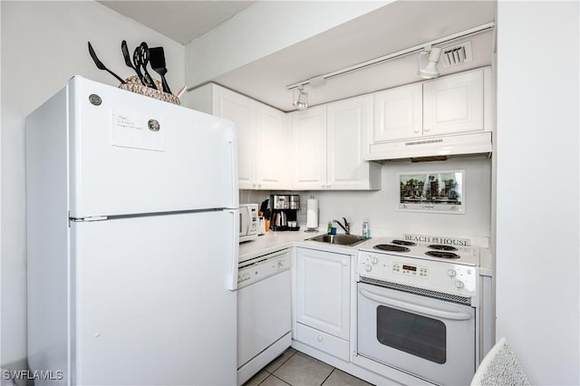 kitchen with white cabinets, light tile patterned floors, white appliances, and sink