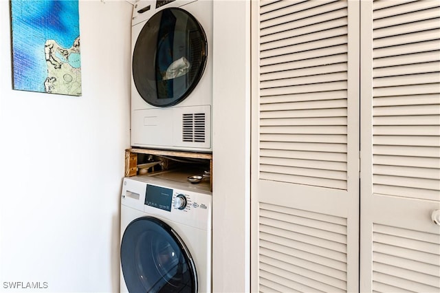 laundry area with stacked washer and clothes dryer