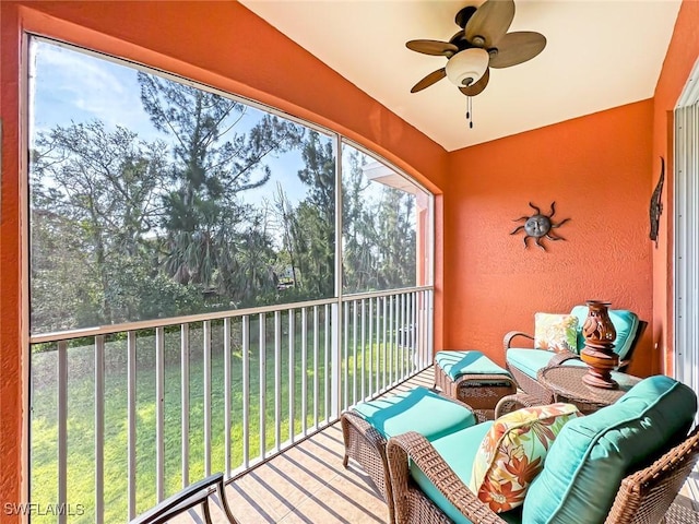 unfurnished sunroom with ceiling fan