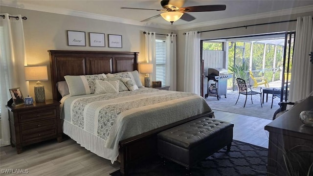 bedroom featuring hardwood / wood-style flooring, ornamental molding, and ceiling fan