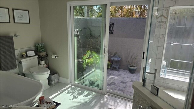 bathroom with a tub and toilet